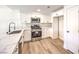 Beautiful kitchen with white cabinets, stainless steel appliances and a quartz countertop with a black faucet at 9303 Gilcrease Ave # 1243, Las Vegas, NV 89149