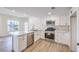 Bright kitchen features white cabinets, stainless appliances, quartz countertops and an island with a sink at 9303 Gilcrease Ave # 1243, Las Vegas, NV 89149