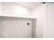 An unfinished laundry room with a shelf and white walls at 9303 Gilcrease Ave # 1243, Las Vegas, NV 89149