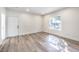 Living room featuring light wood-look flooring, a front door and a window with natural light at 9303 Gilcrease Ave # 1243, Las Vegas, NV 89149
