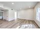 Spacious living room offers recessed lights, light wood-look floors and a view to another room at 9303 Gilcrease Ave # 1243, Las Vegas, NV 89149
