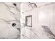 The shower shows marble-style tile walls and a black shower head and niche at 9303 Gilcrease Ave # 1243, Las Vegas, NV 89149