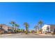 Landscaped streetscape, with palm trees, manicured lawns, and two-story residential buildings at 9303 Gilcrease Ave # 1243, Las Vegas, NV 89149