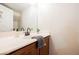 Bathroom vanity features a white countertop, dark wood cabinet, and bronze faucet at 9490 Thunder Sky St # 102, Las Vegas, NV 89178
