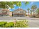Inviting two-story home with a three car garage, balcony, and desert landscaping at 9490 Thunder Sky St # 102, Las Vegas, NV 89178