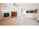 Cozy living room featuring a fireplace, open layout, and seamless transition to the kitchen at 9490 Thunder Sky St # 102, Las Vegas, NV 89178