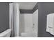 Modern bathroom with a shower and bathtub combination, complemented by gray walls and a white towel at 10001 Peace Way # 2351, Las Vegas, NV 89147