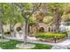 Community outdoor grilling and picnic area with lush green spaces and mature shade trees at 10001 Peace Way # 2351, Las Vegas, NV 89147