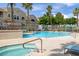 Community pool and spa area with lounge chairs and lush landscaping, creating a serene oasis at 10001 Peace Way # 2351, Las Vegas, NV 89147