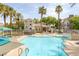 Resort-style community pool with palm trees, lounge chairs, and a spa, perfect for relaxation at 10001 Peace Way # 2351, Las Vegas, NV 89147