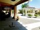 Spacious backyard featuring a covered patio, white gazebo, and meticulously landscaped gravel area at 10015 Wonderful Day Dr, Las Vegas, NV 89148