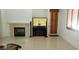 Bright living room with a fireplace, a media center and tiled floors at 10015 Wonderful Day Dr, Las Vegas, NV 89148