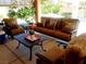Covered patio seating area with comfortable outdoor furniture, perfect for relaxing or entertaining guests at 10015 Wonderful Day Dr, Las Vegas, NV 89148