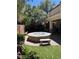 This backyard has a firepit, seating area, and an outdoor kitchen at 10974 Fintry Hills St, Las Vegas, NV 89141