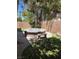 Spacious backyard with stone fire pit and bench seating at 10974 Fintry Hills St, Las Vegas, NV 89141