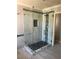 Modern shower featuring decorative tile, glass enclosure, and updated fixtures at 10974 Fintry Hills St, Las Vegas, NV 89141