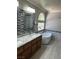 Modern bathroom with double vanity, soaking tub, tile accents, and updated lighting at 10974 Fintry Hills St, Las Vegas, NV 89141