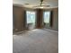 Large, carpeted bedroom featuring neutral tones, providing a comfortable and inviting space at 10974 Fintry Hills St, Las Vegas, NV 89141