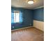 This bedroom offers neutral carpeting, blue walls and white trim, providing a cozy and inviting atmosphere at 10974 Fintry Hills St, Las Vegas, NV 89141