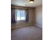 Cozy bedroom with neutral walls, window with curtains, and carpet floors at 10974 Fintry Hills St, Las Vegas, NV 89141
