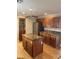 Kitchen featuring a central island, stainless steel refrigerator, and wooden cabinets at 10974 Fintry Hills St, Las Vegas, NV 89141