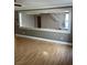 Open living room area featuring wood floors, a decorative interior opening, and staircase views at 10974 Fintry Hills St, Las Vegas, NV 89141