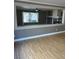 Spacious living area with wood floors, decorative opening, fireplace, and abundant natural light at 10974 Fintry Hills St, Las Vegas, NV 89141