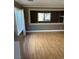Neutral living room with wood floors, natural light from windows, and a decorative interior opening at 10974 Fintry Hills St, Las Vegas, NV 89141