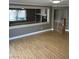 Bright living room with wood floors, interior opening, and view to the backyard at 10974 Fintry Hills St, Las Vegas, NV 89141