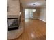 Spacious living room features hardwood floors, a cozy fireplace, and sliding glass doors to the outside at 10974 Fintry Hills St, Las Vegas, NV 89141
