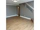 Cozy living room showcasing wood floors and adjacent access to a staircase at 10974 Fintry Hills St, Las Vegas, NV 89141