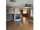 Living room featuring a fireplace, hardwood floors, and view of kitchen at 10974 Fintry Hills St, Las Vegas, NV 89141