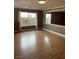 Living room featuring wood flooring and natural light from a nearby window at 10974 Fintry Hills St, Las Vegas, NV 89141