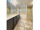Bathroom features a double vanity, tile flooring, soaking tub and glass enclosed shower at 11083 Ketchikan St, Las Vegas, NV 89179