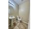 Bathroom with pedestal sink, tile flooring, and neutral color scheme at 11083 Ketchikan St, Las Vegas, NV 89179