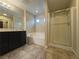 Bathroom featuring a double vanity, soaking tub, and glass enclosed shower at 11083 Ketchikan St, Las Vegas, NV 89179