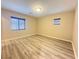 Bedroom with wood flooring and natural light from two windows at 11083 Ketchikan St, Las Vegas, NV 89179