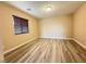 Bedroom featuring wood-style floors and a window with modern blinds at 11083 Ketchikan St, Las Vegas, NV 89179