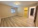 This bedroom has wood look floors, a closet, and access to an ensuite bathroom at 11083 Ketchikan St, Las Vegas, NV 89179