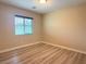 Bedroom with neutral walls, wood flooring, and a window providing natural light at 11083 Ketchikan St, Las Vegas, NV 89179
