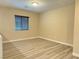 Bright bedroom with wood-style flooring and a window with modern blinds at 11083 Ketchikan St, Las Vegas, NV 89179