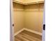 A walk-in closet with wood look floors, baseboards, shelving, and a rod at 11083 Ketchikan St, Las Vegas, NV 89179