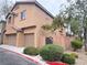 Double garage with a tidy driveway and attractive landscaping along the perimeter of the property at 11083 Ketchikan St, Las Vegas, NV 89179