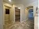 Hallway leading to bedroom, walk-in closet, and bathroom featuring tile and wood flooring at 11083 Ketchikan St, Las Vegas, NV 89179