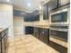 Modern kitchen featuring dark cabinets, stainless steel appliances, and granite countertops at 11083 Ketchikan St, Las Vegas, NV 89179