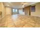 Bright living area featuring neutral colors, tile floors, large windows, and a seamless flow to the kitchen at 11083 Ketchikan St, Las Vegas, NV 89179