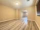 Spacious living room with wood-style floors and natural light at 11083 Ketchikan St, Las Vegas, NV 89179