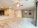 Open-concept living area with tile flooring, ceiling fan, and easy access to the kitchen at 11083 Ketchikan St, Las Vegas, NV 89179
