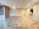 Expansive living area with tile flooring, ceiling fan, and ample space for furniture arrangement at 11083 Ketchikan St, Las Vegas, NV 89179