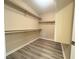 Spacious walk-in closet with wood flooring and shelving for ample storage space at 11083 Ketchikan St, Las Vegas, NV 89179